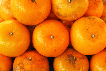 Close up of many orange piles in the market, orange fruit texture background.