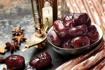 Composition with tasty dates and Muslim lamp on table