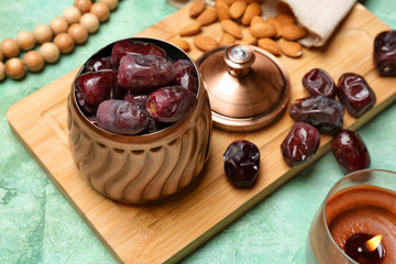 Vase with tasty dates on color background