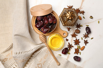 Obraz na płótnie Canvas Composition with tasty dates, Muslim lamp and honey on table