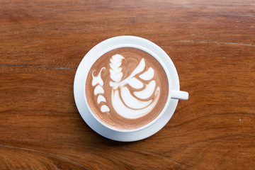 Coffee cup with latte art foam on wood table in coffee shop with copy space.Coffee is one of the most popular beverages.Improve Energy Levels and Burn Fat