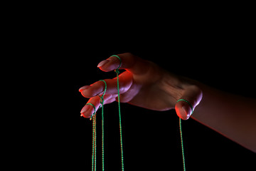 Hand of puppeteer on dark background