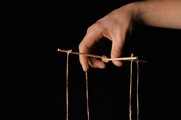 Hand of puppeteer on dark background