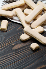 Fototapeta na wymiar Italian Savoiardi ladyfingers Biscuits on wooden backgound with copy space