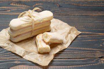 Italian Savoiardi ladyfingers Biscuits on wooden backgound with copy space