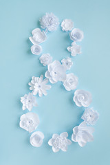 Figure 8 from white paper flowers on blue background