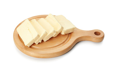 Board with cut butter on white background