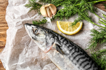 Tasty raw mackerel fish with dill, lemon and garlic on parchment