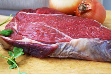 Fresh raw beef steak  on wooden background, top view 