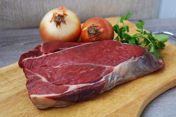 Fresh raw beef steak  on wooden background, top view 