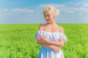 Fototapeta na wymiar Woman on a nature, spring - summer season, concept of freedom life, lady in white linen dress 