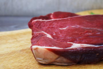 Fresh raw beef steak  on wooden background, top view 