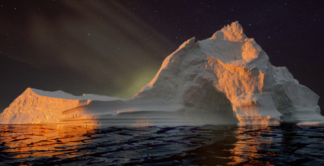 Iceberg with cave at night. Elements of this image furnished by NASA.