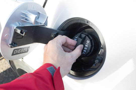 Pumping Petrol At Gas Station Into Vehicle.hand Using A Fuel Nozzle At A Gas Station.Petrol Gasoline In Cold Weather Safe Drive Concept.