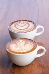 Coffee cup with latte art foam on wood table in coffee shop with copy space.Coffee is one of the most popular beverages.Improve Energy Levels and Burn Fat