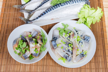 Sliced smoked and salted Atlantic mackerel against of raw fish
