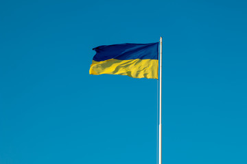 Ukrainian flag on blue sky background