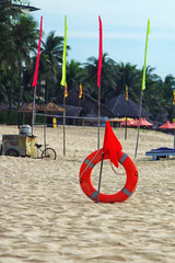 red flag with a lifebuoy on the beach