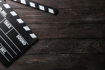 Cinema clapperboard on wooden background