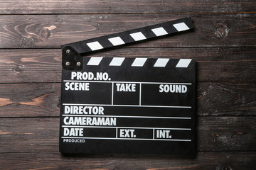 Cinema clapperboard on wooden background