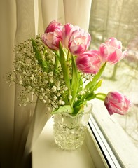 Bouquet of tulips on the window