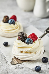 dessert from a meringue, butter cream and fresh berries