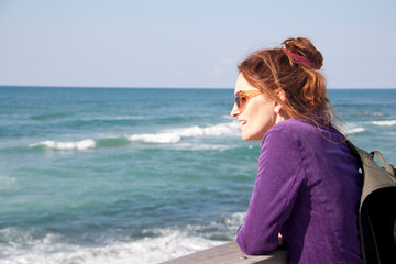 Portrait of a female tourist on a blurred sea background