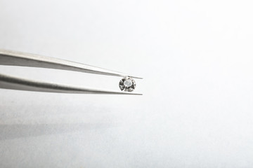 Pincer with precious stone for jewellery on light background