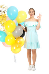 Beautiful young woman with balloons on white background