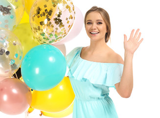 Beautiful young woman with balloons on white background
