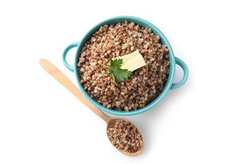Pot with tasty boiled buckwheat on white background