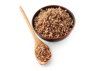 Bowl with tasty boiled buckwheat on white background