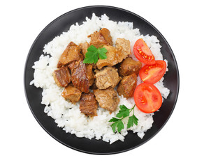 black plate with white rice and goulash isolated on white background. top view