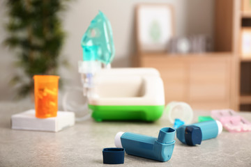 Inhalers with pills on table at home