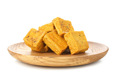Wooden plate with tasty tofu cheese on white background