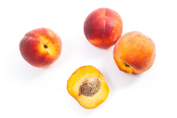 Fototapeta na wymiar Group of ripe peach fruit and a half isolated on white background.