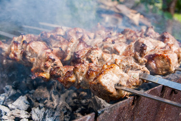 Traditional eastern dish, shish kebab. Roasted meat cooked at barbecue with smoke. .