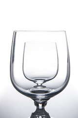 Two wine glasses isolated on light background.