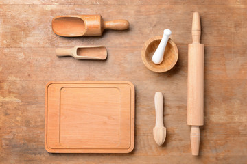 Set of wooden kitchen utensils on table