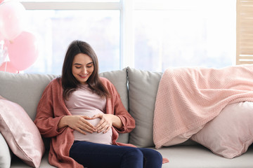 Beautiful pregnant woman resting at home