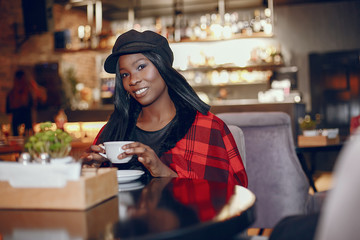 Elegant black girl in a cafe