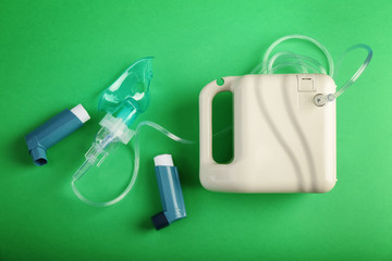 Nebulizer and inhalers on color background