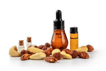 nut oil bottles with nuts mix isolated on white background