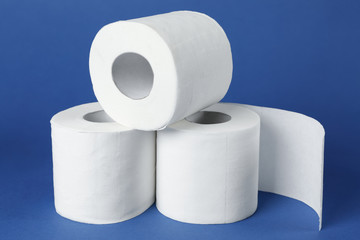 Rolls of toilet paper on color background