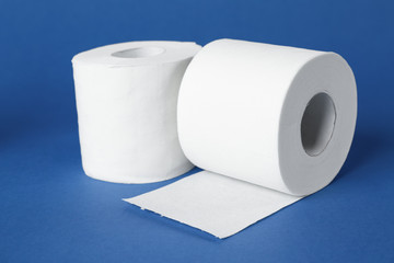 Rolls of toilet paper on color background