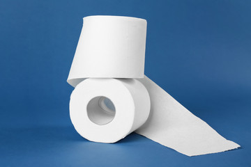 Rolls of toilet paper on color background