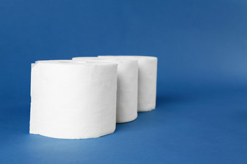 Rolls of toilet paper on color background