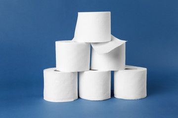 Rolls of toilet paper on color background