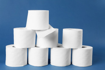 Rolls of toilet paper on color background