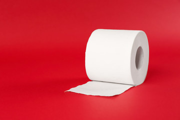 Roll of toilet paper on color background